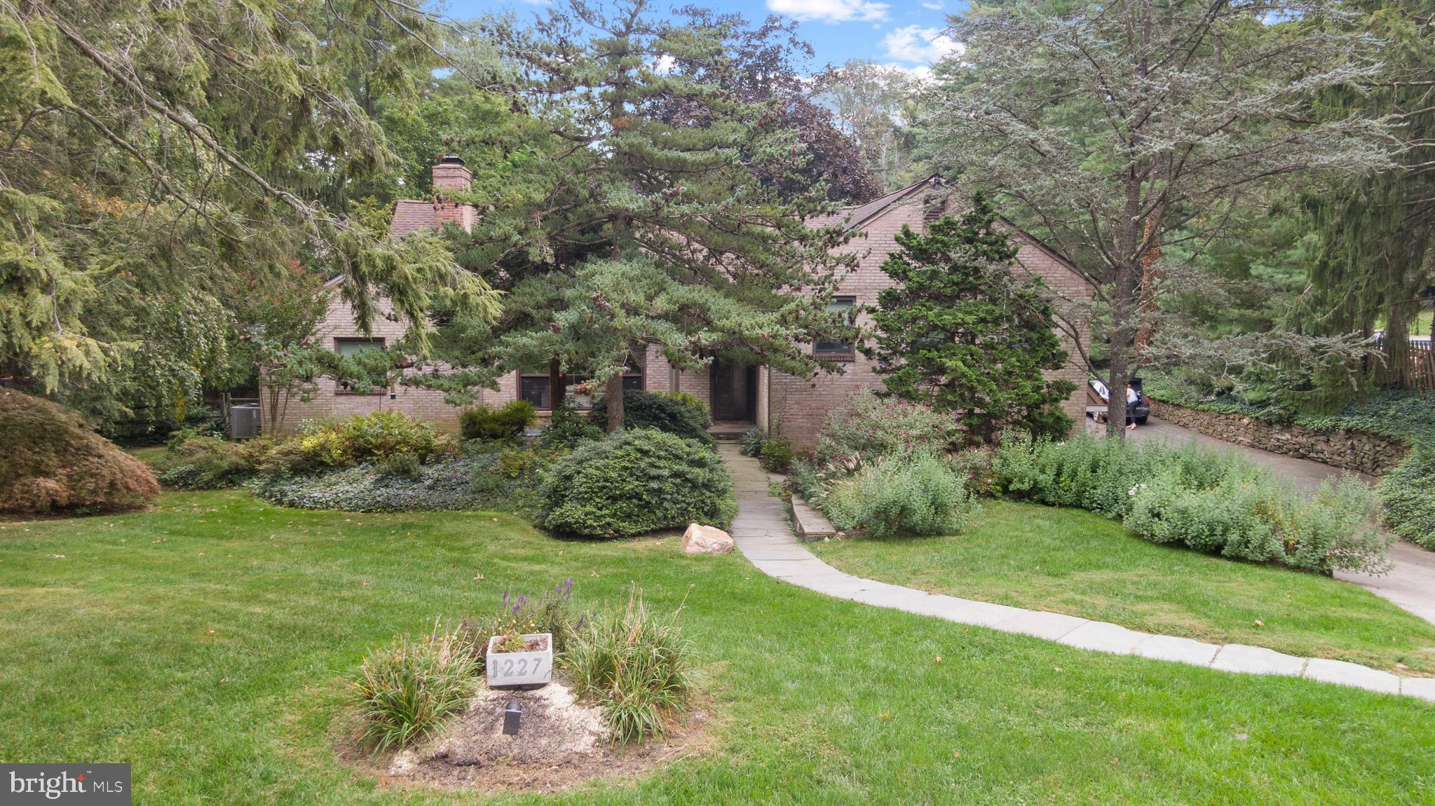 1227 Pinewood Road Villanova, PA 19085 - Photo 2 of 43 a view of a garden with a fountain