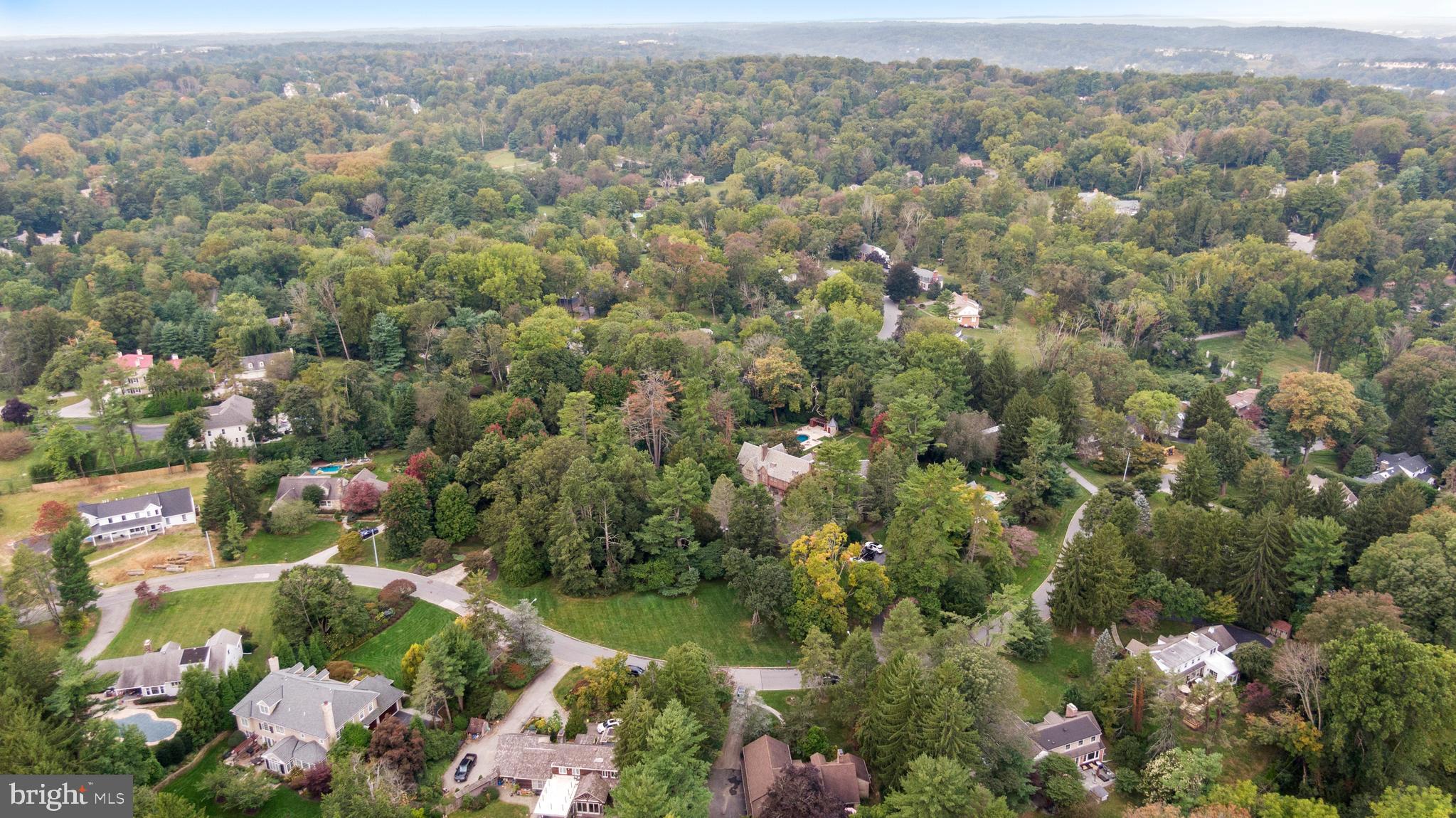 1227 Pinewood Road Villanova, PA 19085 - Photo 42 of 43 an aerial view of a houses with a lush green hillside
