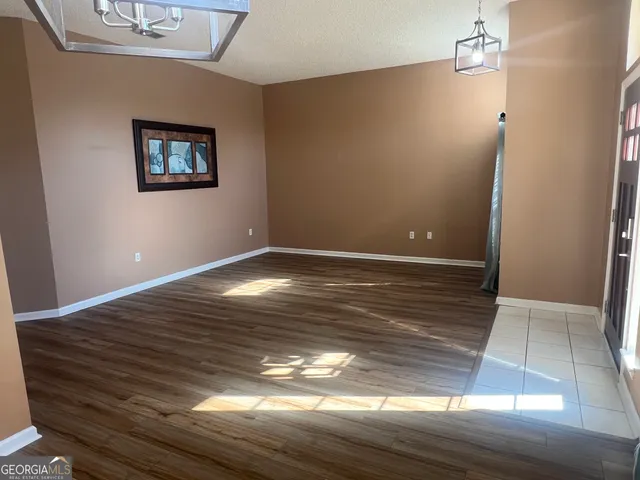 a view of a room with wooden floor and window
