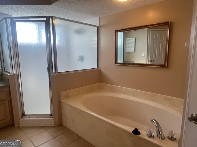 a bathroom with bathtub and shower