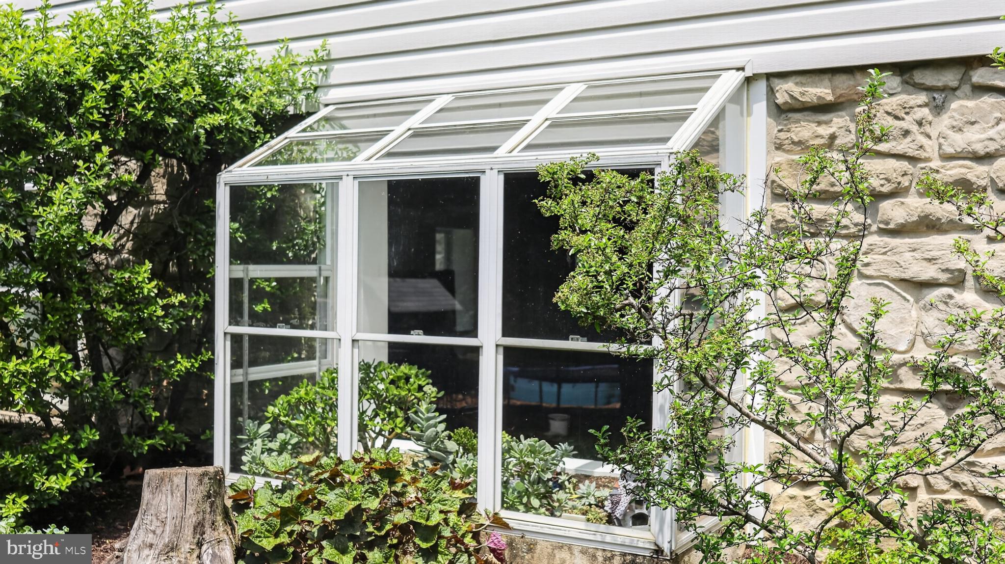 257 Hill Road New Holland, PA 17557 - Photo 34 of 94 Charming greenhouse nestled in greenery.