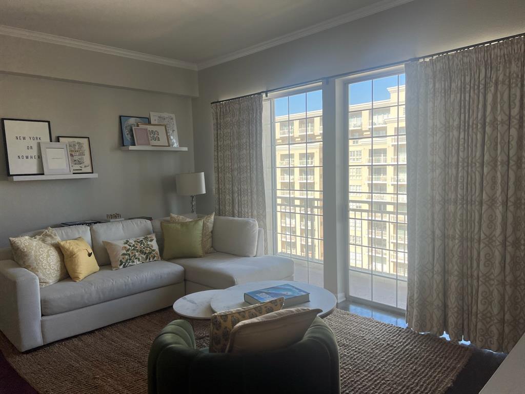 3225 Turtle Creek Boulevard, Unit 1706 Dallas, TX 75219 - Photo 2 of 13 a living room with furniture and a window