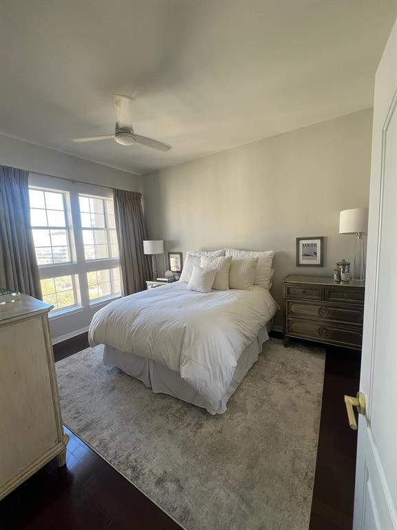 3225 Turtle Creek Boulevard, Unit 1706 Dallas, TX 75219 - Photo 3 of 13 a spacious bedroom with a bed and wooden floor
