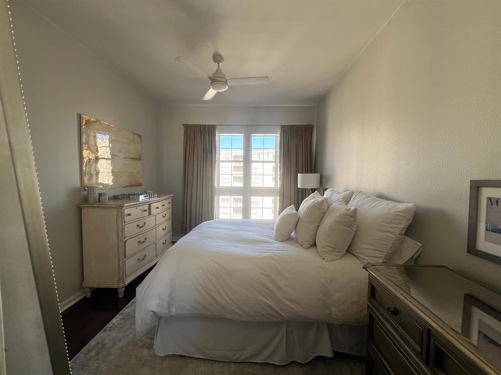 3225 Turtle Creek Boulevard, Unit 1706 Dallas, TX 75219 - Photo 4 of 13 a bedroom with a bed and a window