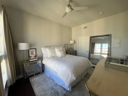a bedroom with a bed next to a window