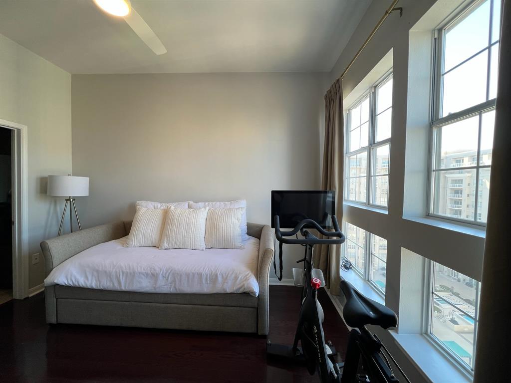 3225 Turtle Creek Boulevard, Unit 1706 Dallas, TX 75219 - Photo 8 of 13 a bedroom with a bed and wooden floor