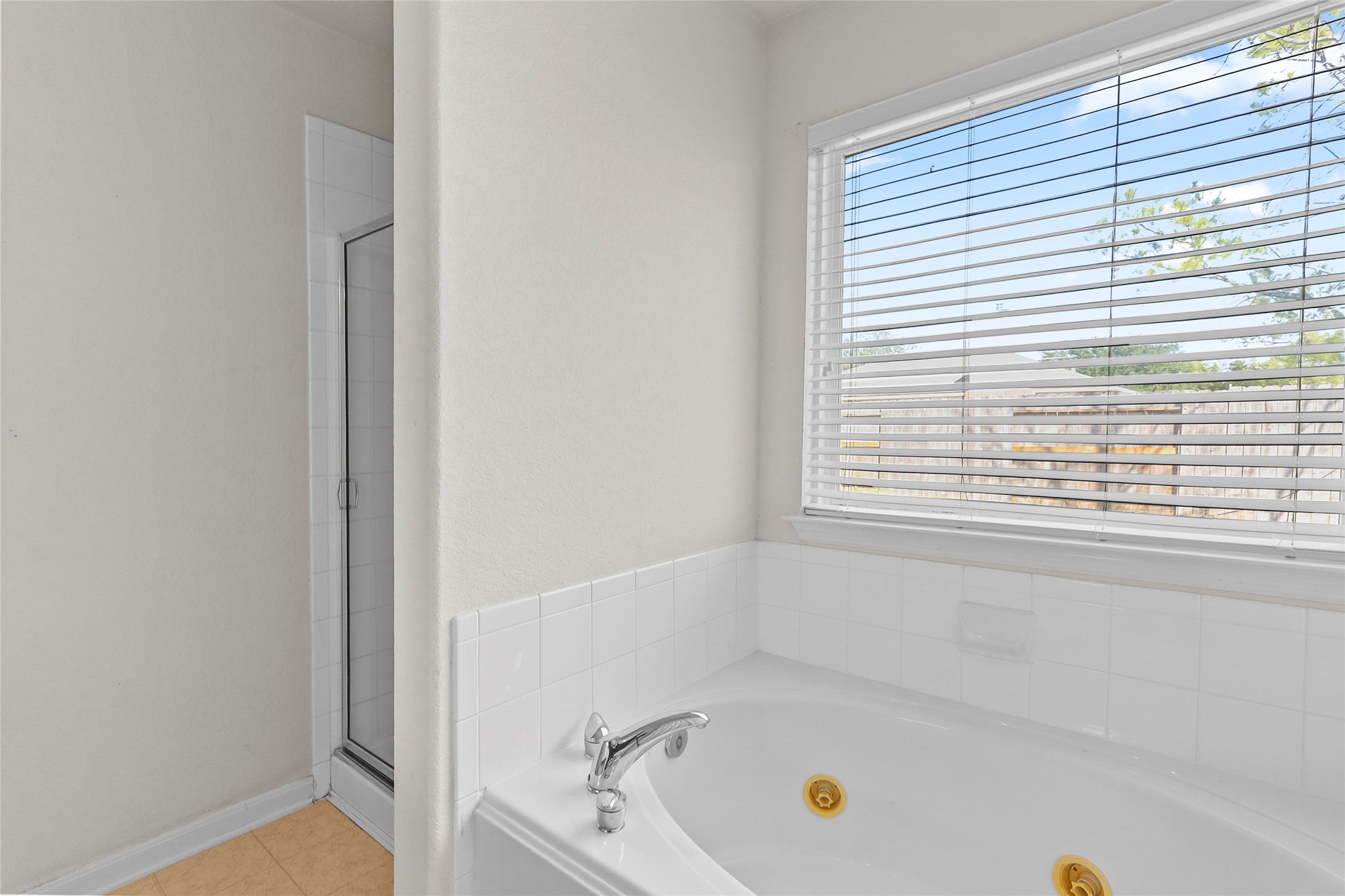 13006 Arden Ridge Lane Houston, TX 77014 - Photo 2 of 11 a bathroom with a bathtub and a window