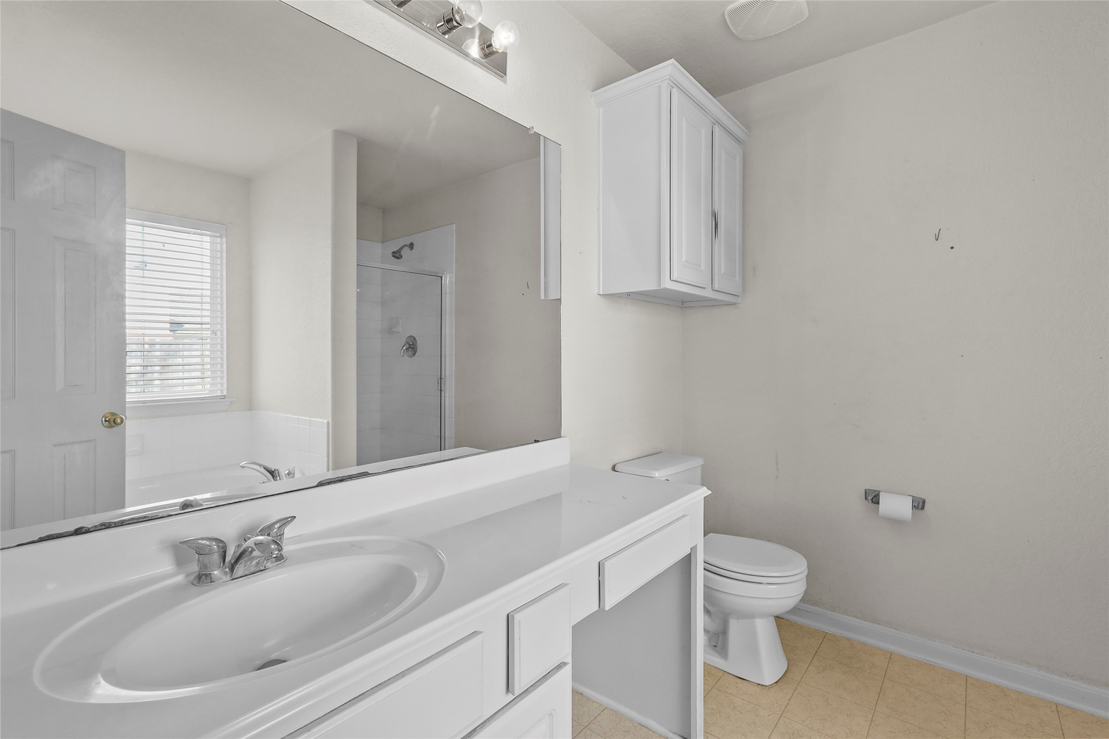 13006 Arden Ridge Lane Houston, TX 77014 - Photo 3 of 11 a bathroom with a toilet sink and mirror