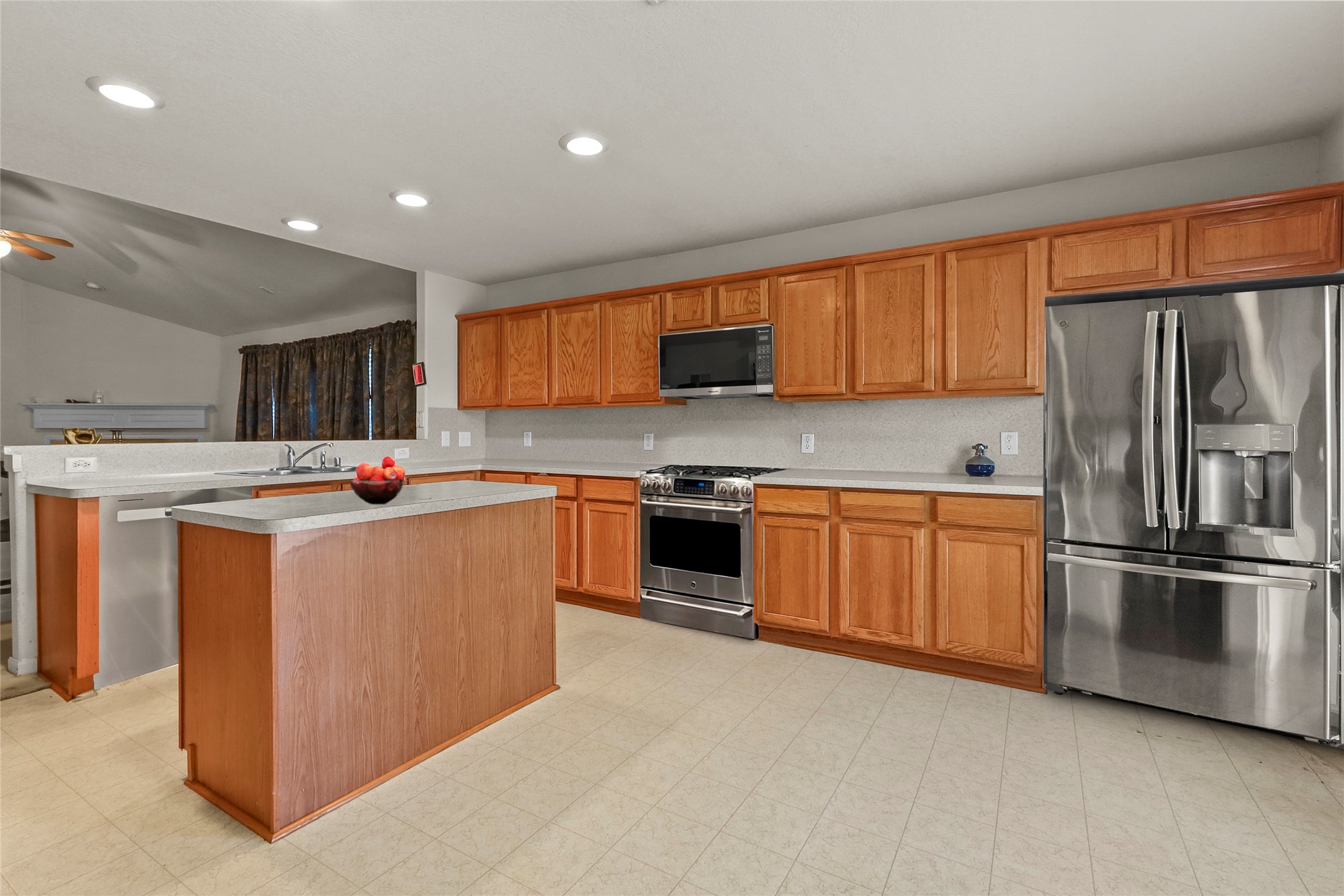 13006 Arden Ridge Lane Houston, TX 77014 - Photo 10 of 11 a kitchen with stainless steel appliances kitchen island granite countertop a stove top oven a sink and a refrigerator