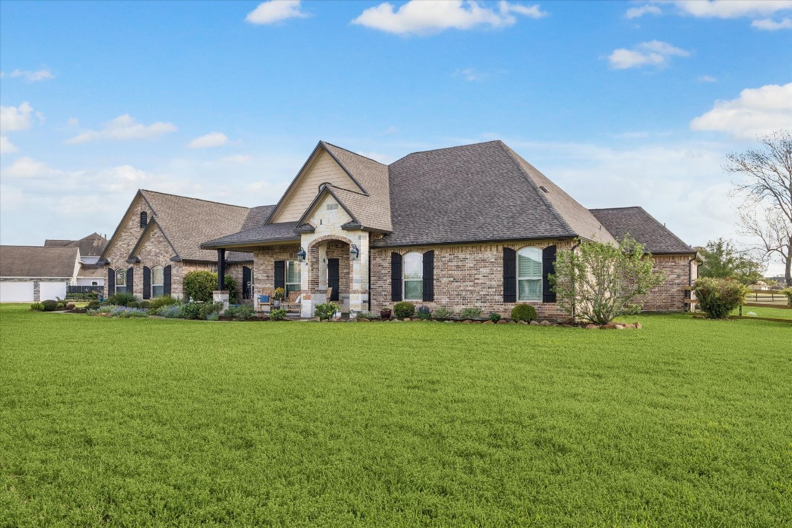 17703 Cedarhill Drive Rosharon, TX 77583 - Photo 2 of 47 The thoughtfully designed roofline and timeless brick and stone façade showcase the scale and craftsmanship of this one-of-a-kind custom home, with mature landscaping framing every angle.