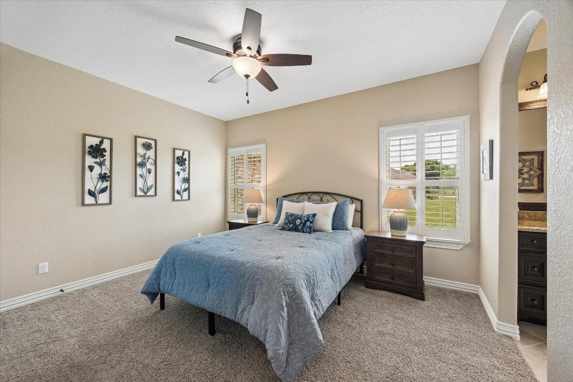 17703 Cedarhill Drive Rosharon, TX 77583 - Photo 21 of 47 The second secondary bedroom offers ample space, plantation shutters with peaceful acreage views, ceiling fan, and convenient access to the shared Jack-and-Jill bath — perfect for kids or visiting guests.