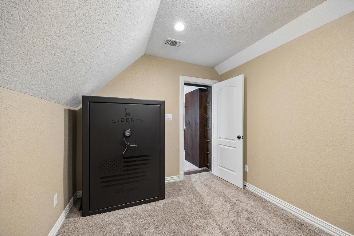 17703 Cedarhill Drive Rosharon, TX 77583 - Photo 28 of 47 Behind the bookcase door lies a dedicated safe room housing a fire-resistant Liberty safe — a rare and impressive feature offering peace of mind and secure storage that truly sets this home apart.