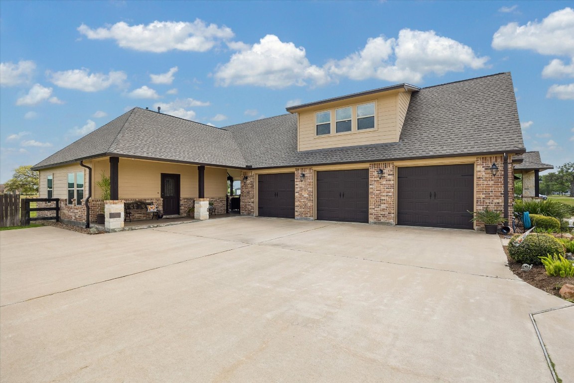 17703 Cedarhill Drive Rosharon, TX 77583 - Photo 38 of 47 The oversized 3-car garage is built wider and deeper than standard — offering generous space for large vehicles, equipment, and storage. To the right, a private entry leads directly to the detached casita, providing guests or extended family with their own completely independent access.
