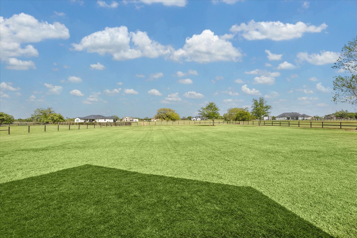17703 Cedarhill Drive Rosharon, TX 77583 - Photo 40 of 47 Two full acres of pristine, fenced acreage stretch out behind the home — perfectly level, lush, and beautifully maintained — offering endless possibilities for a pool, sport court, garden, or simply wide open Texas skies and room to roam.