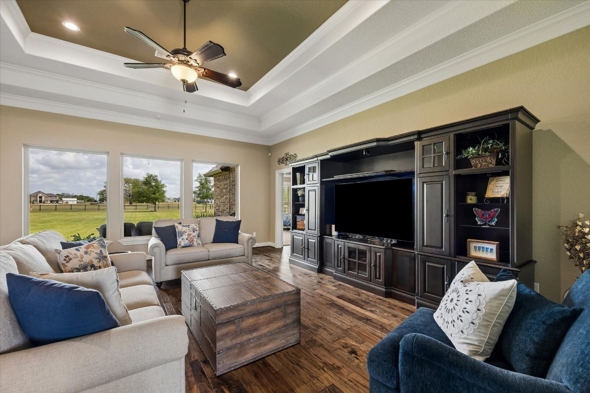 17703 Cedarhill Drive Rosharon, TX 77583 - Photo 9 of 47 Designed for both relaxing and entertaining, the generous living room features a striking tray ceiling, oversized windows with sweeping acreage views — the perfect gathering space for family and friends.