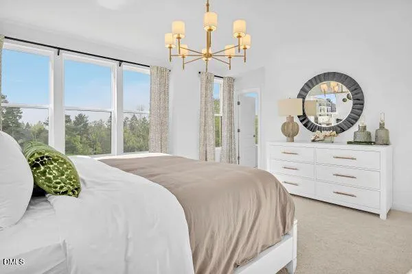 a bedroom with a bed mirror and a window