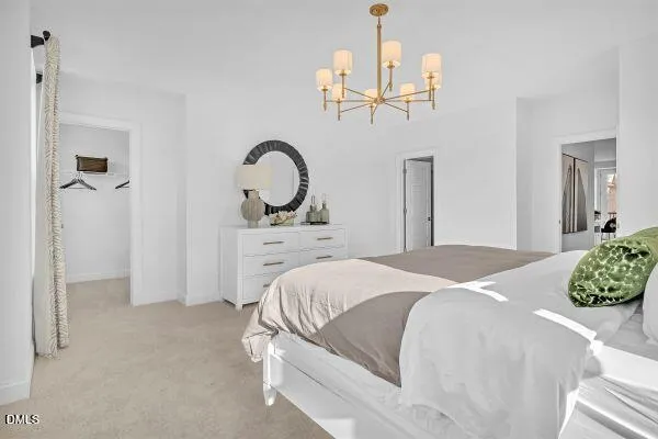 a bedroom with a bed and chandelier