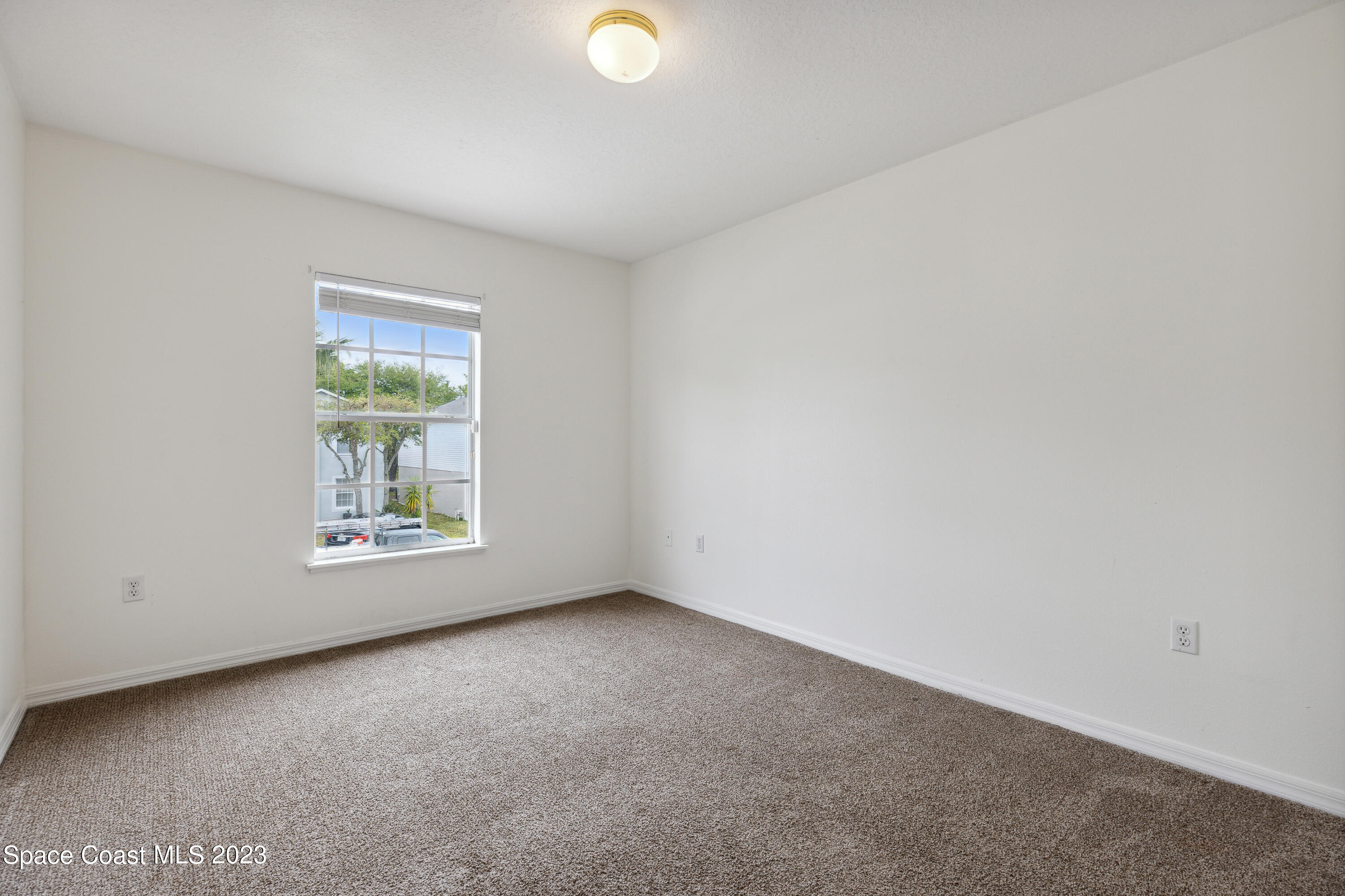 4625 Elena Way Melbourne, FL 32934 - Photo 16 of 26 a view of an empty room with a window
