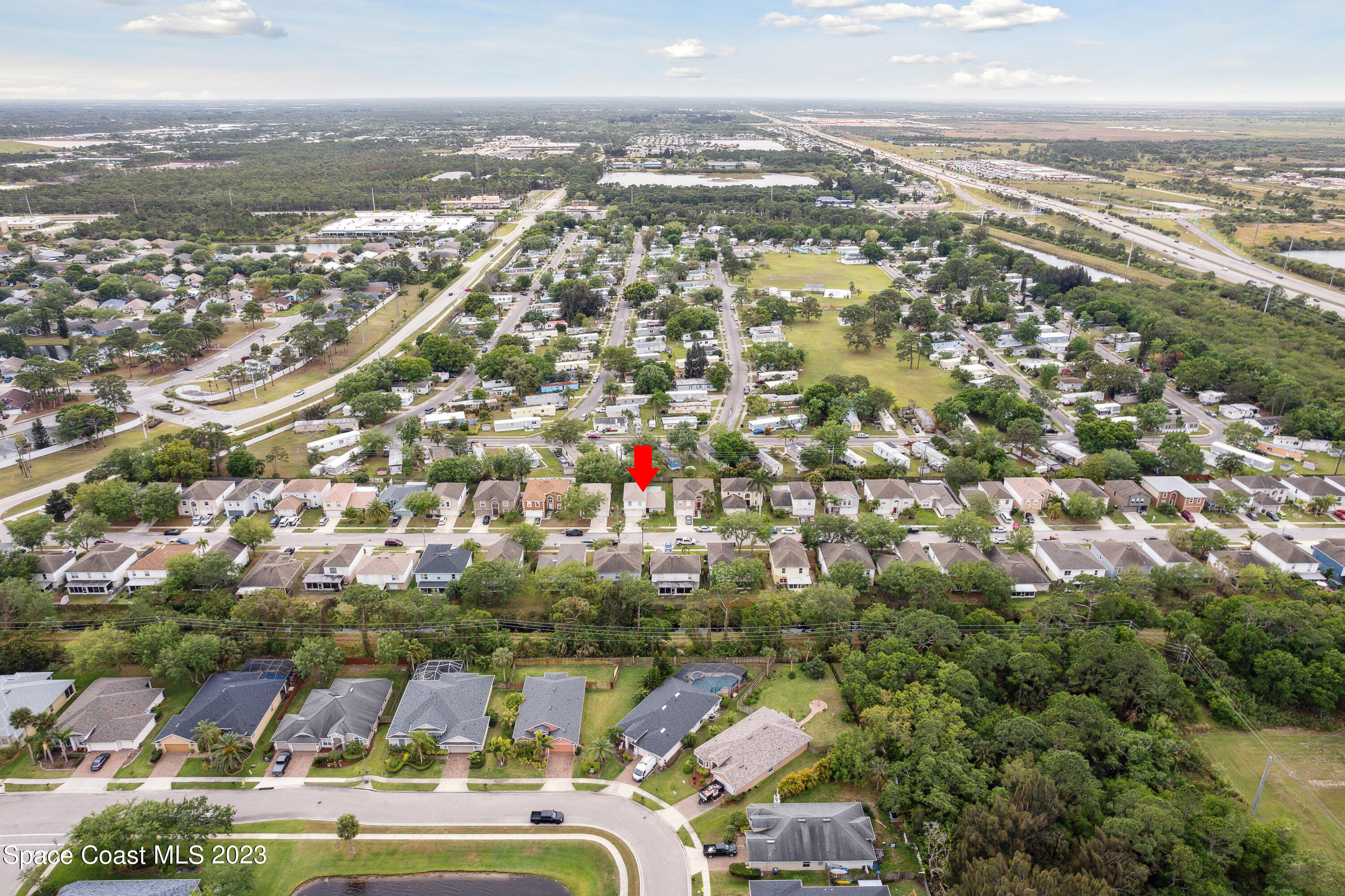 4625 Elena Way Melbourne, FL 32934 - Photo 24 of 26 an aerial view of residential building with parking