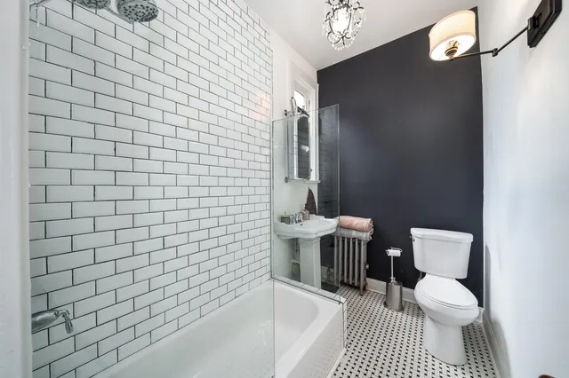 a bathroom with a toilet and a shower