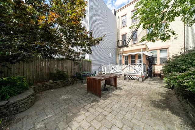 a view of a chairs and table in backyard of the house