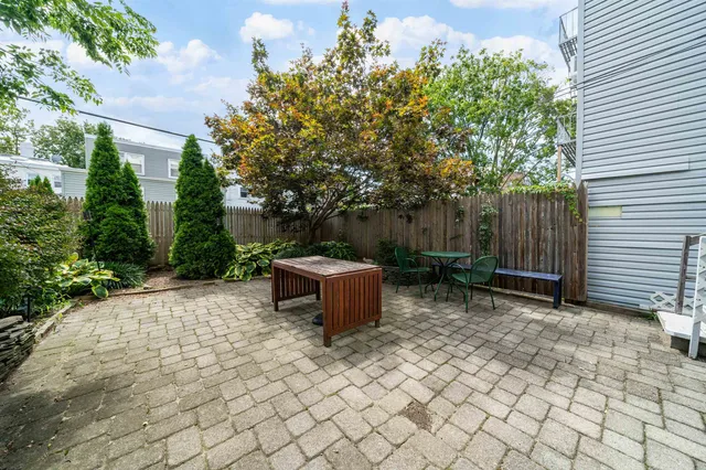a backyard of a house with yard and outdoor seating