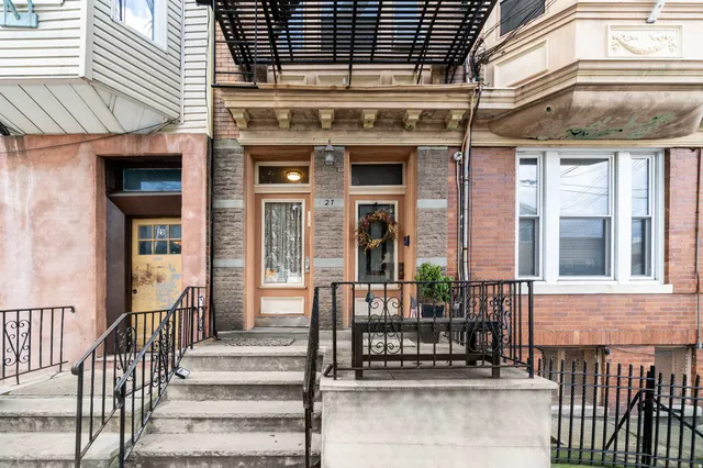 a view of a brick house with large windows