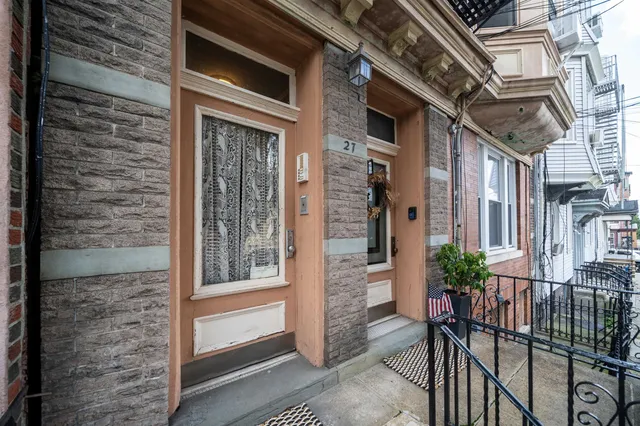 a view of a brick house with many windows