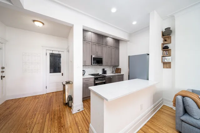 a kitchen with a refrigerator and a stove top oven