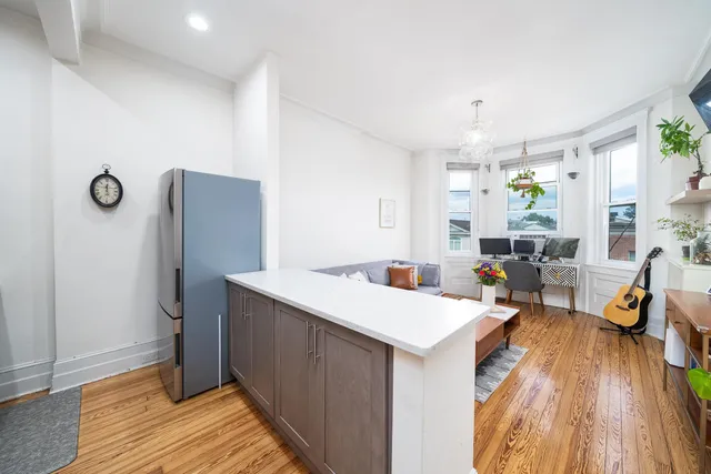 a view of a kitchen with a sink stainless steel appliances and cabinets
