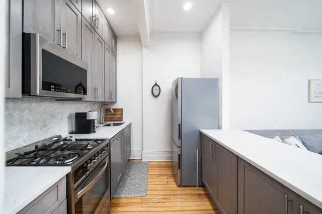 a kitchen with a sink stove and refrigerator