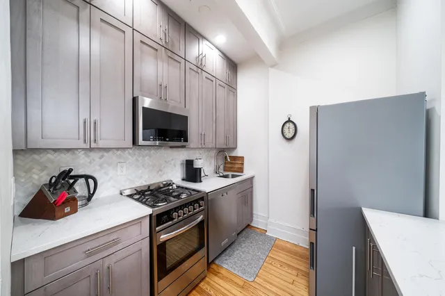 a kitchen with stainless steel appliances a cabinets a stove top oven a sink and dishwasher