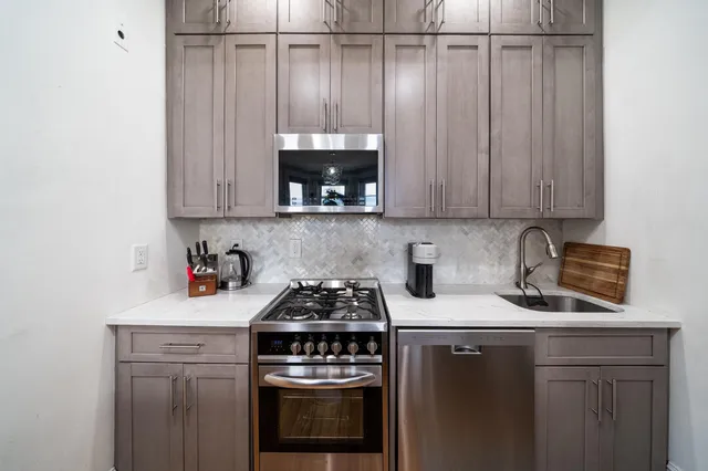 a kitchen with a stove and cabinets