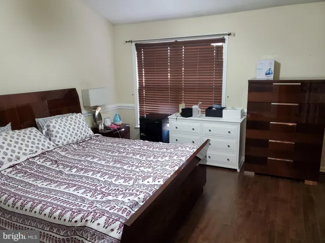 a bedroom with a bed and two windows