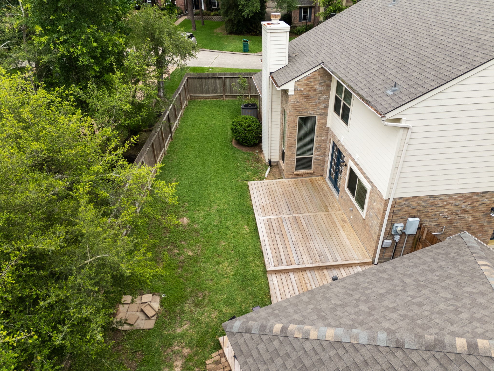 59 Fire Flicker Place Spring, TX 77381 - Photo 16 of 37 Spacious backyard with surrounding greenery, offering privacy and plenty of outdoor space.