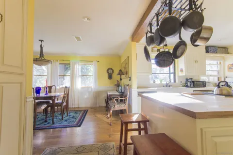 a very nice looking room with kitchen island furniture and a wooden floor