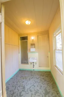 a view of a livingroom with wooden floor and a window