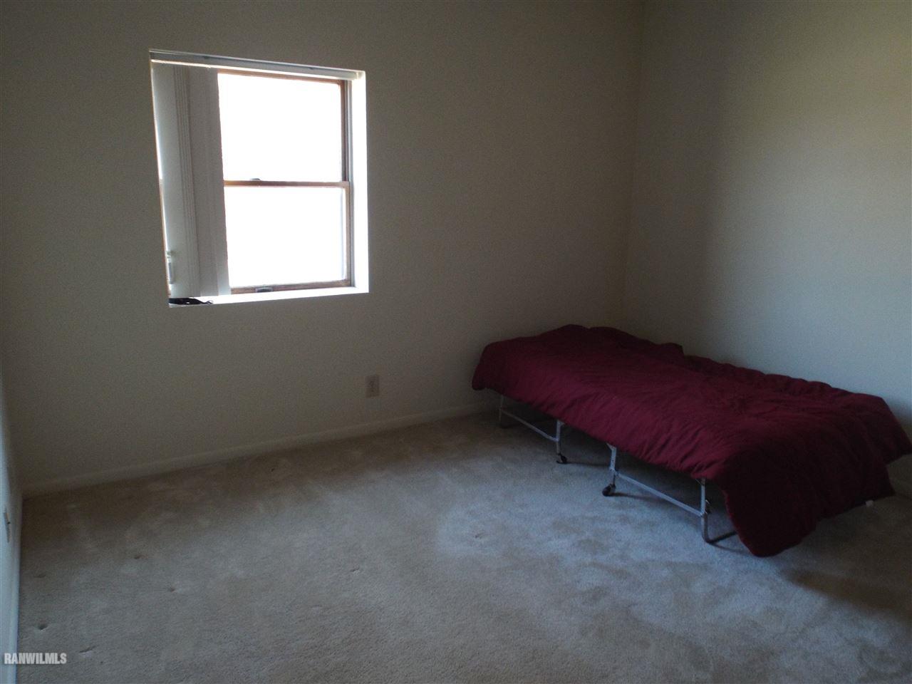 10110 Getz Road Mount Carroll, IL 61053 - Photo 8 of 18 a room with a bed and a window