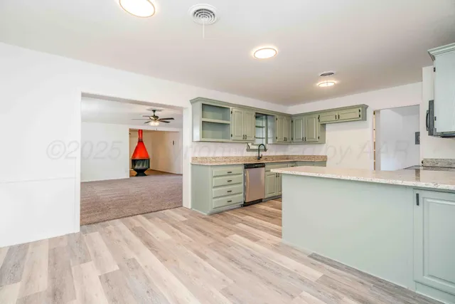 a view of kitchen with sink microwave and refrigerator