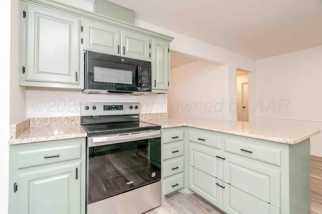 a kitchen with cabinets and window