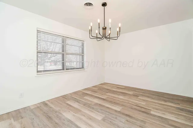 a view of a room with a ceiling fan and a window