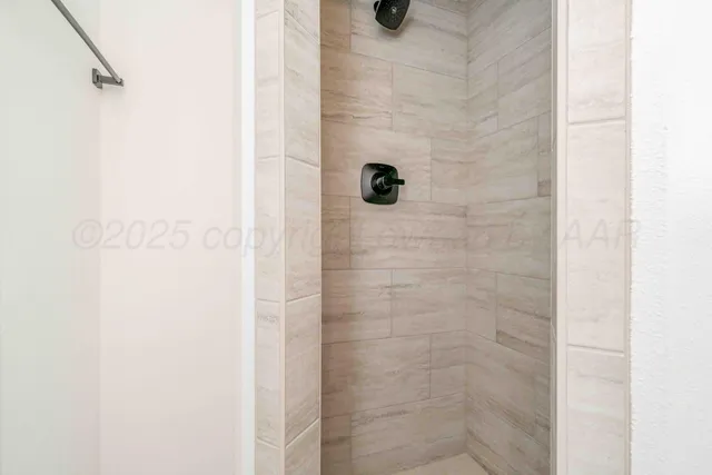 an empty room with a window and ceiling fan