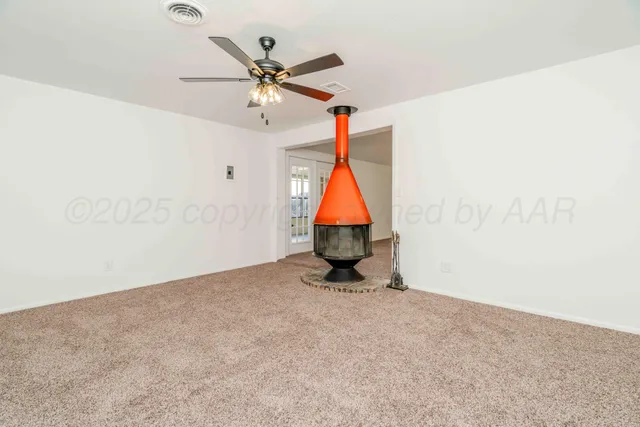 a view of a chandelier fan in the room