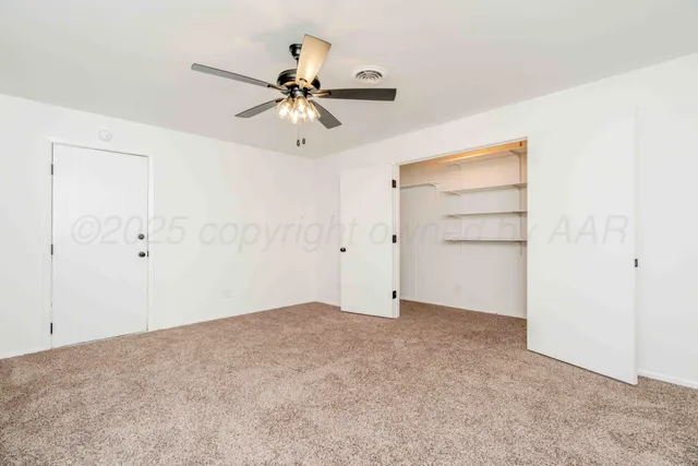 a kitchen with white cabinets and sink