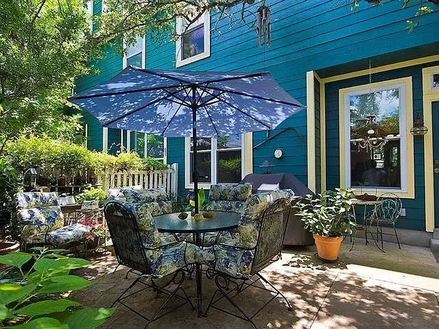 a view of a patio with table and chairs potted plants
