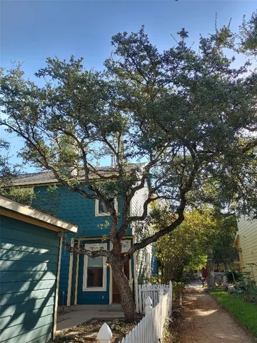 a view of a house with a tree