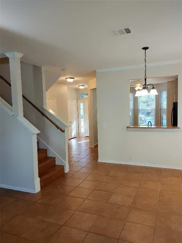 a view of entryway and hall with a chandelier