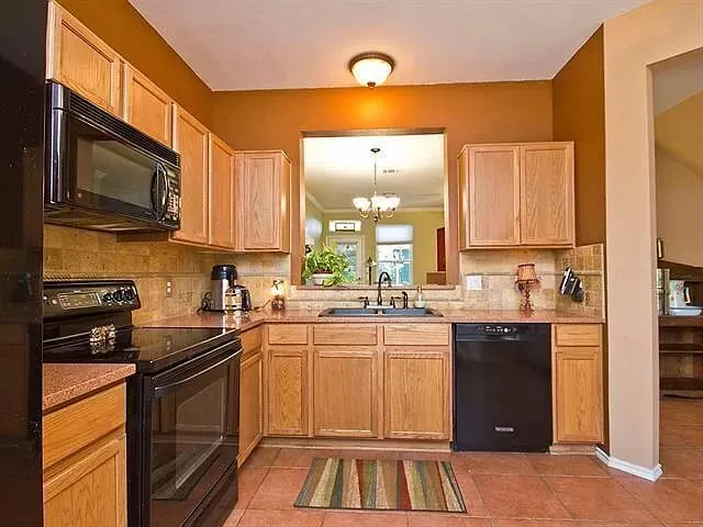 a kitchen that has a sink and a stove top oven