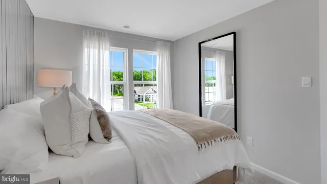 a bed sitting in a bedroom next to a window