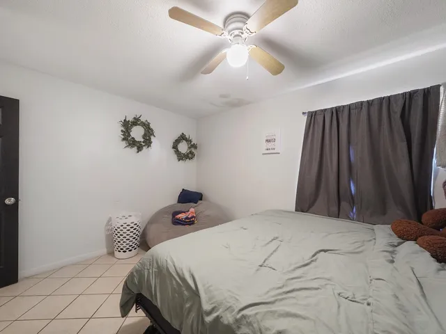 a bedroom with a bed and a wall painting